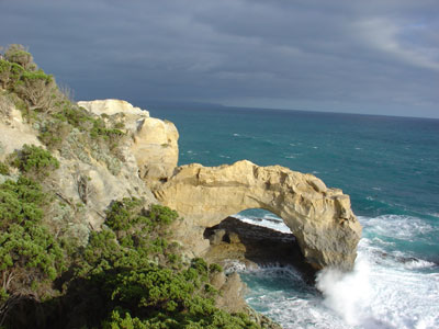 Rock arch, with wave crashing at base