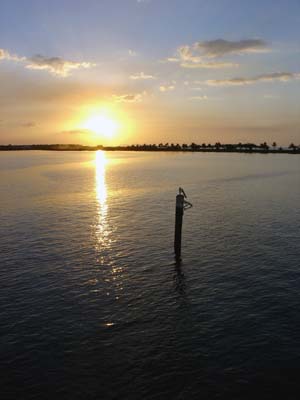 Sunset with a pole in the foreground.