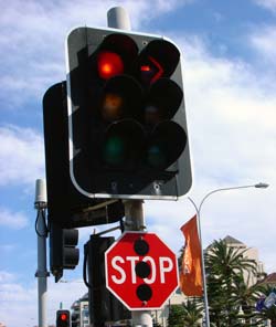 Traffic signal with stop sign beneath it
